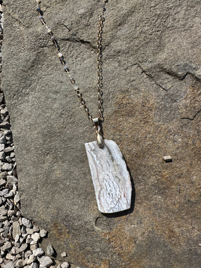 geo white necklace pendant up close 
